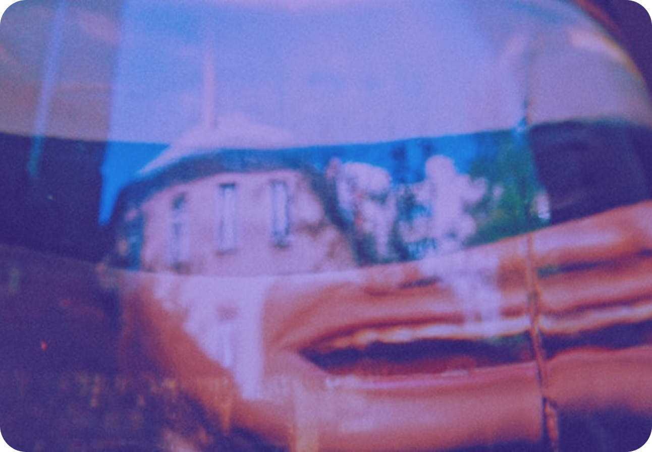 A building distorted and warped behind a sheet of rippled plastic, tinted blue and orange